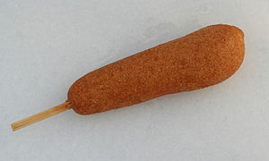 English: A hand-dipped corn dog on a stick, se...