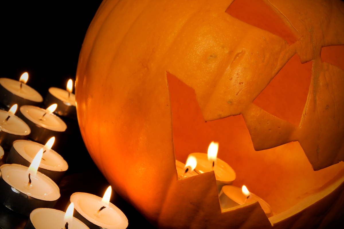 halloween pumpkin and candles in a darkness