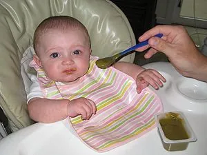 Baby eating baby food (blended green beans) Baby eating baby food (blended green beans)