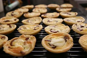 Mini goat cheese tarts on a rack. Mini goat cheese tarts on a rack.