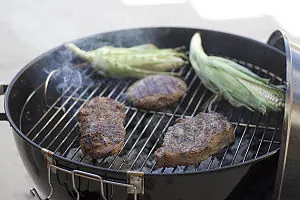 Beef and Corn on a Charcoal BBQ grill Beef and Corn on a Charcoal BBQ grill