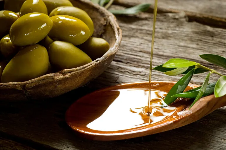 olive oil over spoon