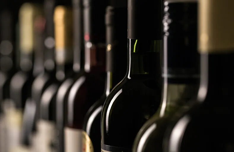 Row of vintage wine bottles in a wine cellar (shallow DOF; color