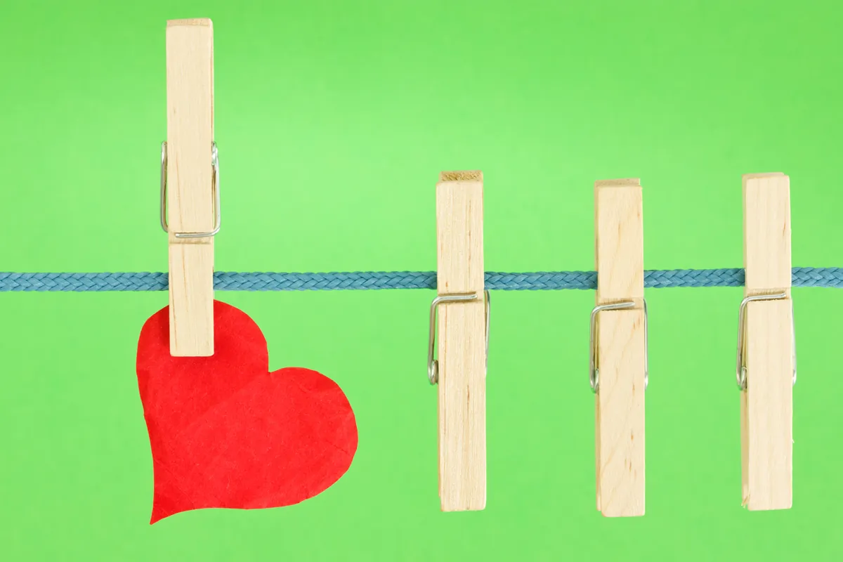 clothesline with a red heart, hung on green background