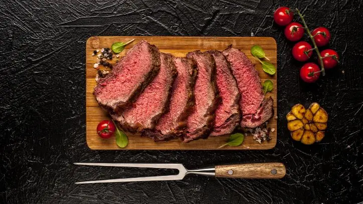 Sliced beef on a wood cutting board
