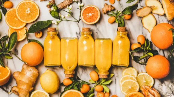 5 bottles of orange and ginger wellness shots