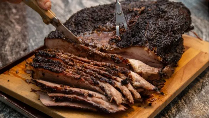 sliced beef brisket on a cutting board