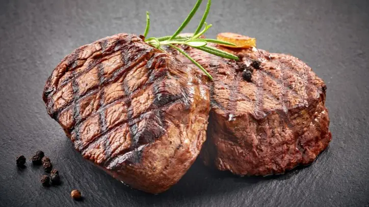 Two cooked beef steaks