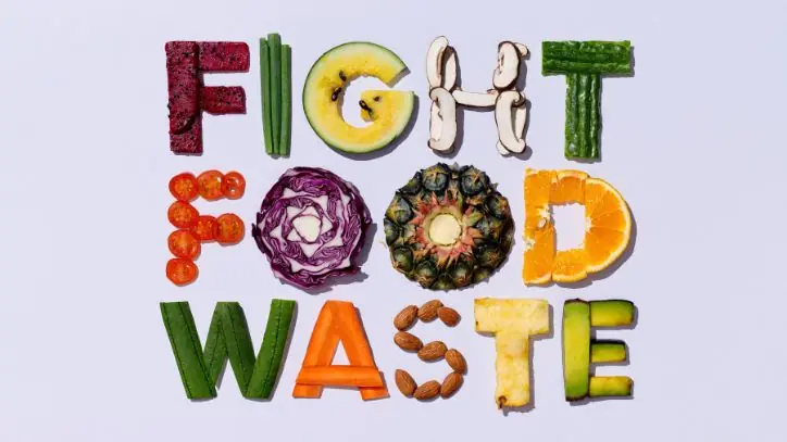 pieces of food that spell out "fight food waste"