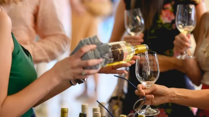 pouring a glass of wine at a party