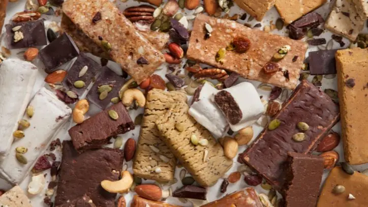 different protein bars scattered on a counter