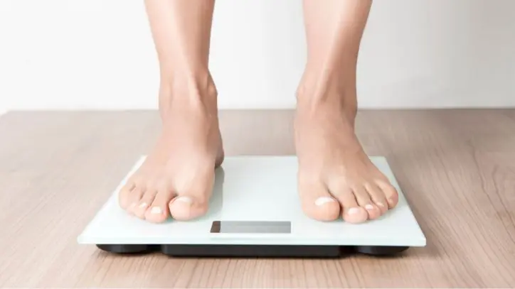 Woman standing on a scale