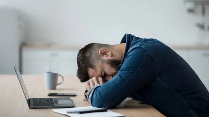 Man with his head down on a table