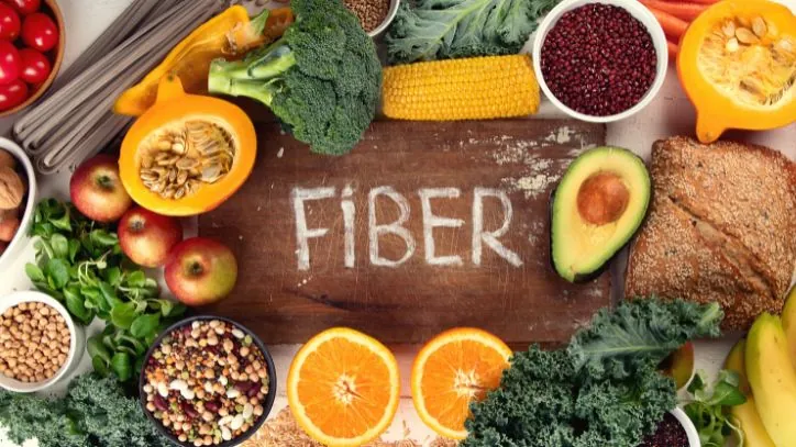 Various fiber rich foods around a cutting board
