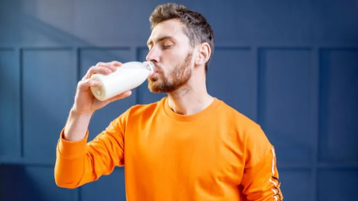 Man drinking a glass of milk