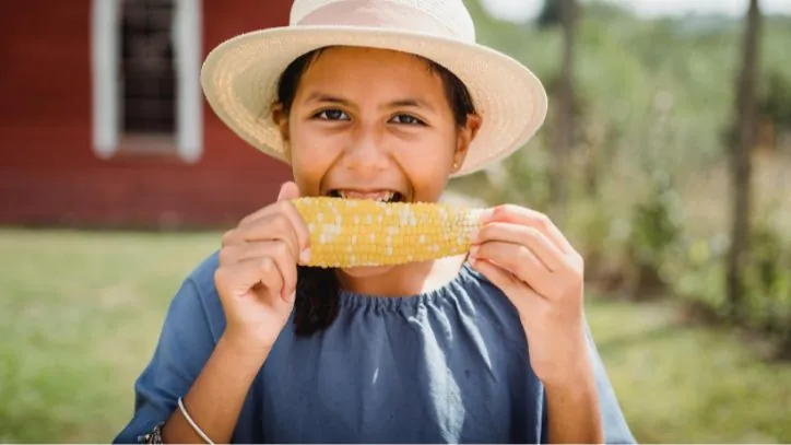 girl eating corn on the cobb