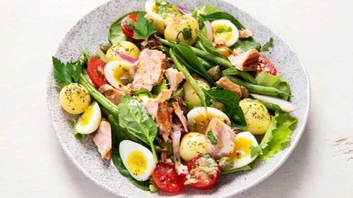 Healthy Salad with fish on top in a bowl