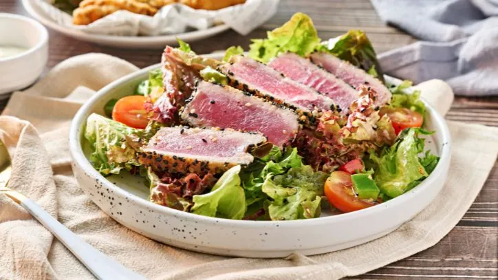 Sliced Ahi Tuna on top of a salad