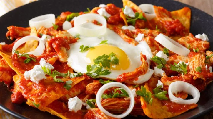 Plate of Chilaquiles topped with a fried egg