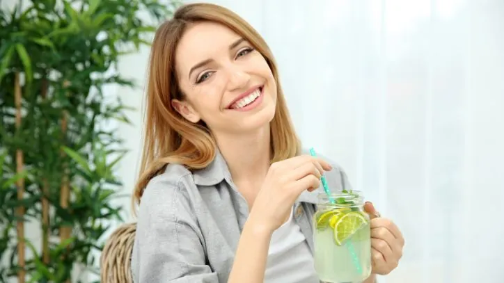 Woman drinking lemon water