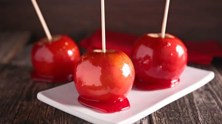 Three Candies Apples on a white platter