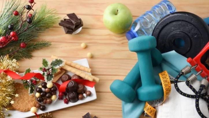 A mix of weights, an apple, water with holiday treats, scattered on the floor