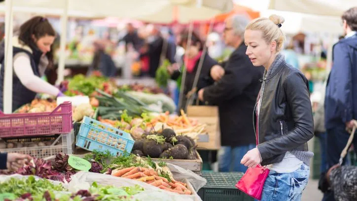 Woman exploring an outdoor Farmer's Market