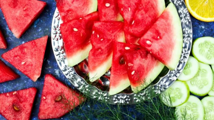 Cut up watermelon, cucumbers and oranges