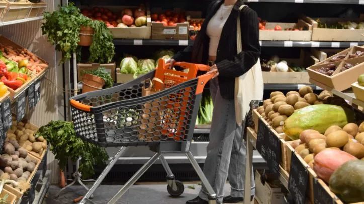 Woman pushing a shopping cart in a grocery store
