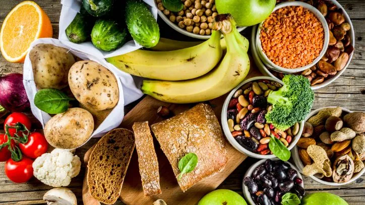 Serveal types of healthy carbs on a wooden table
