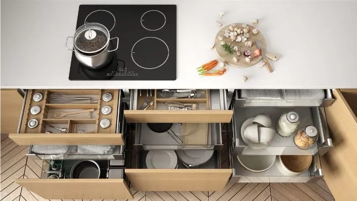 Several kitchen drawers pulled partially open to reveal their organized contents