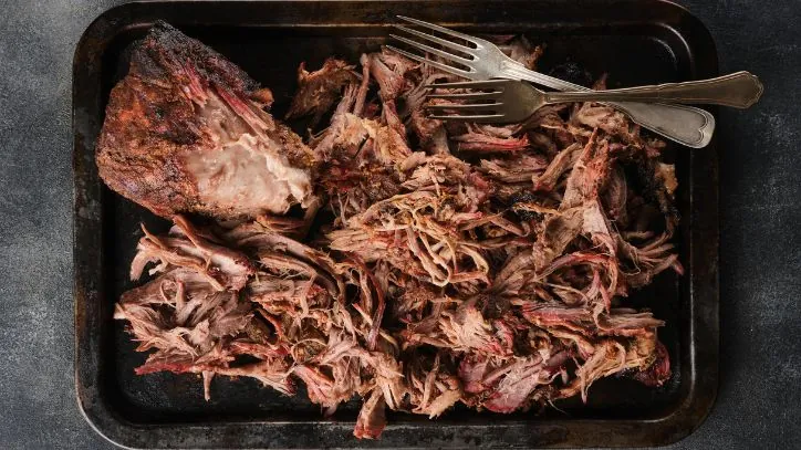 schredded pork shoulder in a pan