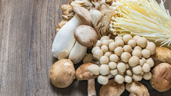 Various types of mushrooms on a wooden table